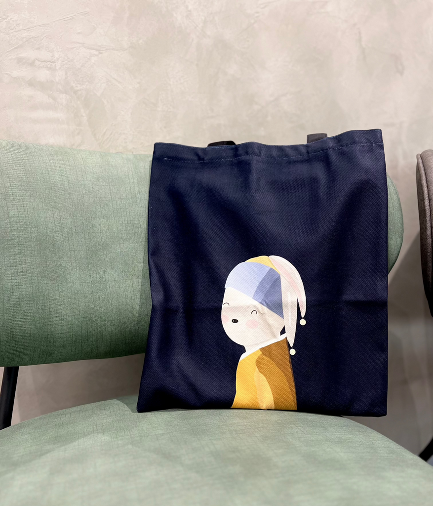 A dark blue cotton tote bag with an illustration of a bunny, imitating the famous painting of 