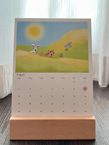 Calendar with drawing of the animal characters sweating and panting because the weather was way too hot. The calendar is placed on the wooden stand