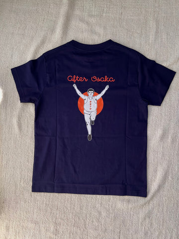 The picture shows the back of a dark blue t-shirt. The illustration is inspired by the famous Glico man in Osaka, with a humourous twist where the Glico man was shown to gain weight after Osaka trip