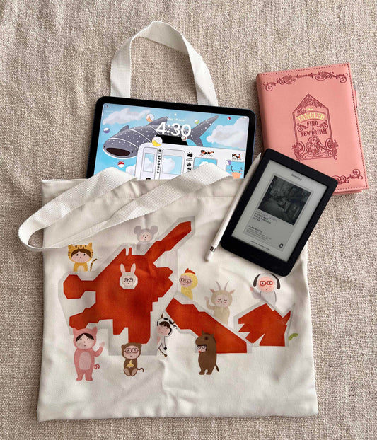 The image shows a cotton tote bag with illustration of Singapore's famous dragon playground. There are children dressing up in Chinese zodiac animals, i.e. bunny, tiger, rat etc) surrounding the playground, featuring the 12 Chinese zodiacs 