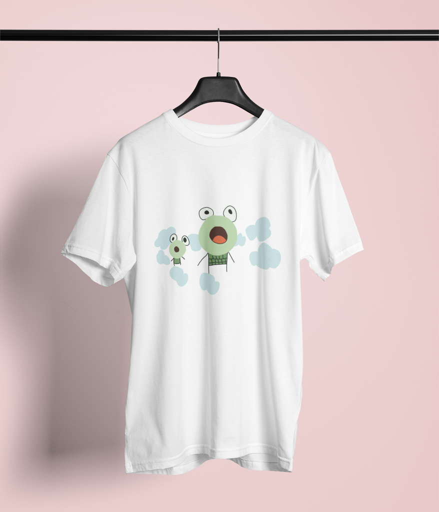 White T-shirt with a graphic design on the front. The design features two cartoonish, child drawn, wide-eyed frogs with expressive faces. The larger character, in the center, has a round face with a surprised expression, while the smaller character, to the left, has a similar expression. Both characters are surrounded by light blue, cloud-like shapes, adding a whimsical touch. The T-shirt is displayed on a hanger against a plain background.